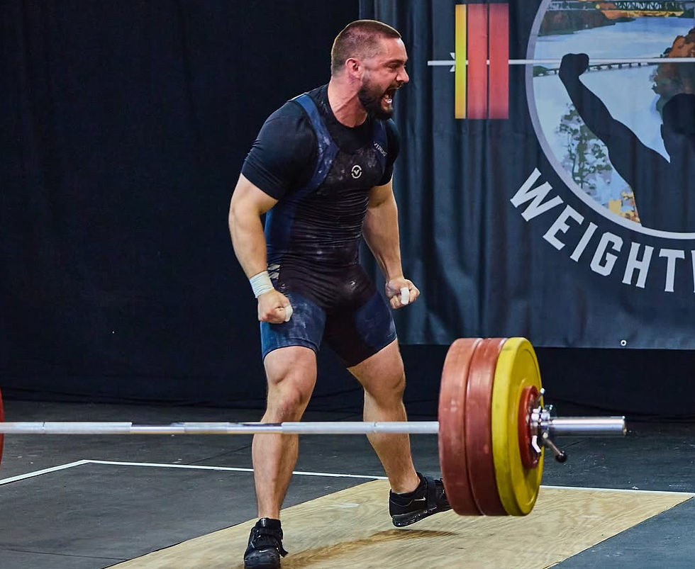 Eye-level view of a barbell loaded with weights on a gym floor