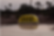 Yellow taxi sign on car at dusk with palm trees