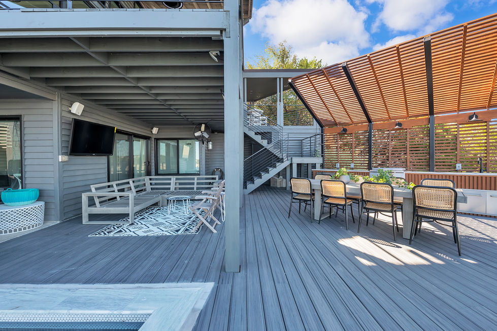 Outdoor deck remodeling project featuring multi-level composite decking, contemporary railing, and seamless transitions between dining, lounge, and pool zones in Austin, TX.