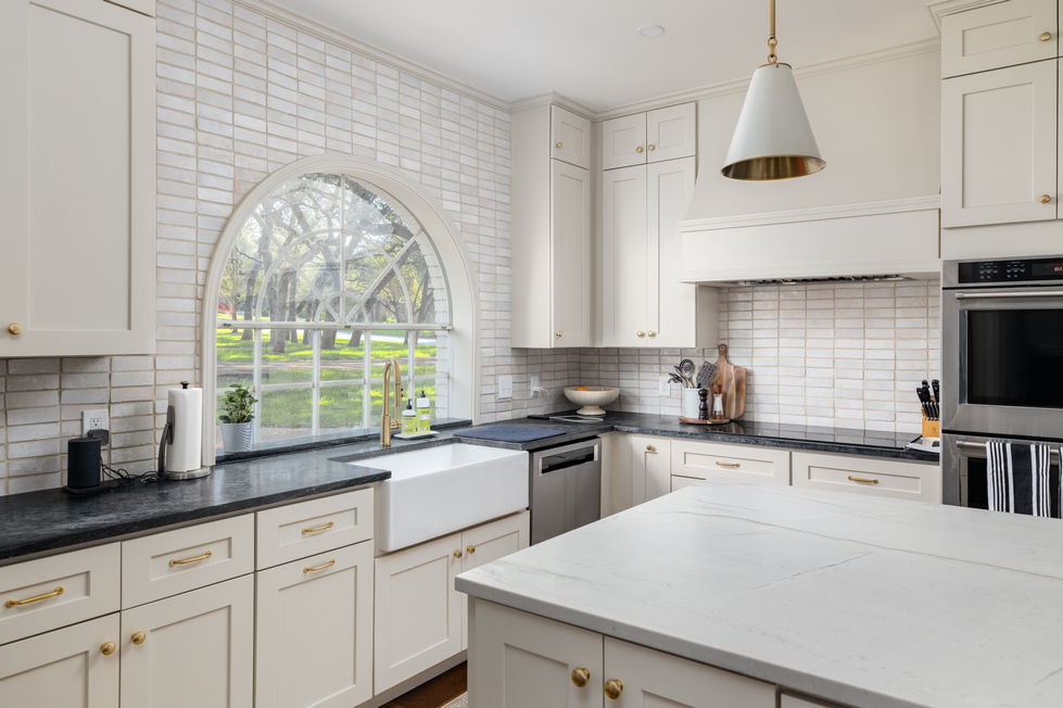 Kitchen remodel with arched window, textured subway tile backsplash, modern gold lighting, and farmhouse sink in Austin, TX.