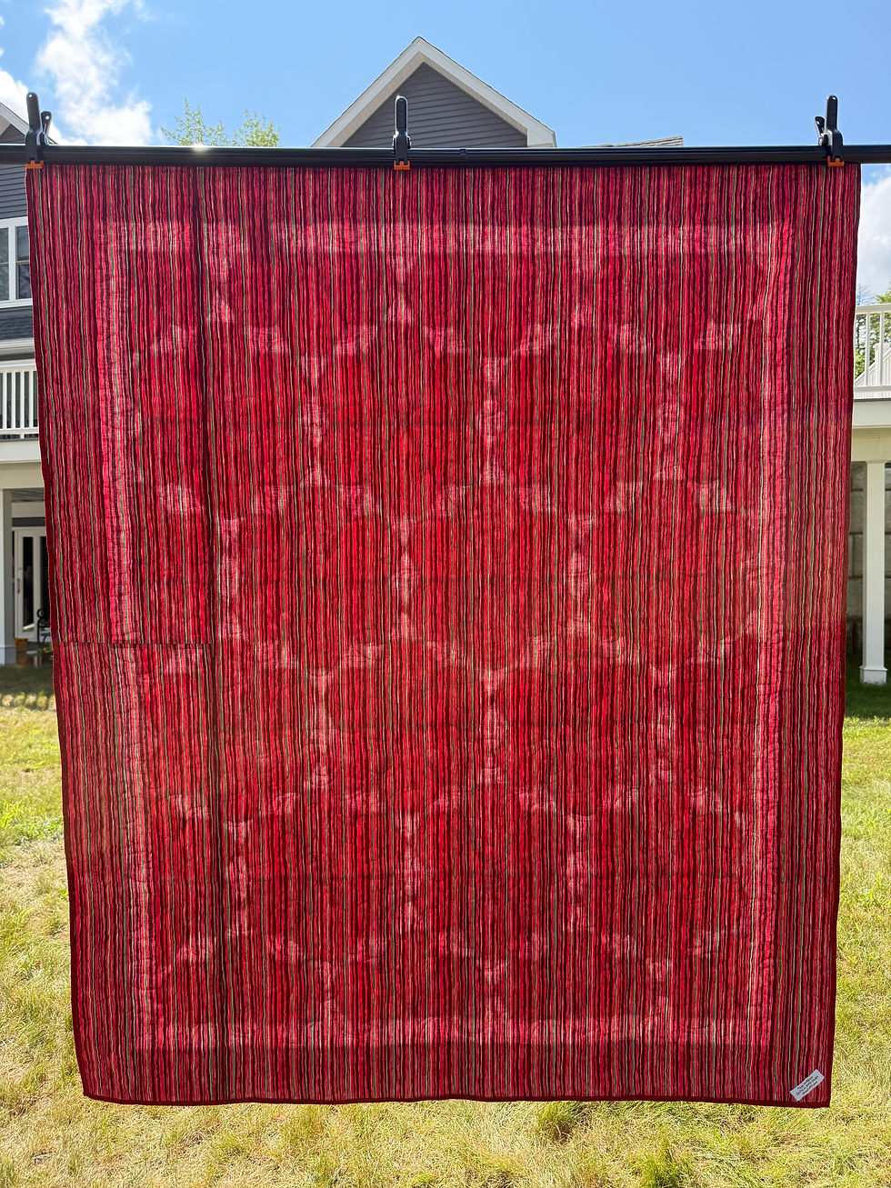 Thumbnail: Throw quilt with red jewel blocks in various prints separated by white diamonds with red border