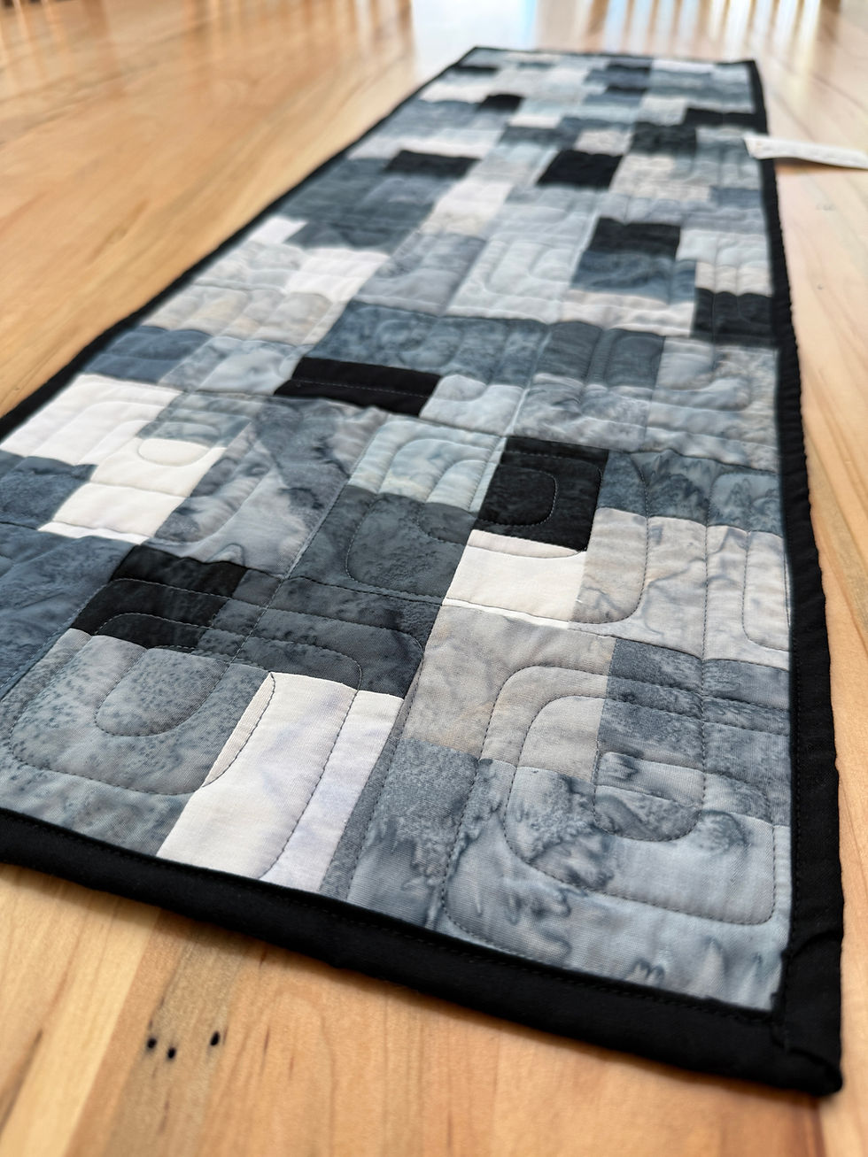 Thumbnail: Modern quilted table runner with blocks in gray, black, and white fabrics with Bauhaus geometric quilting