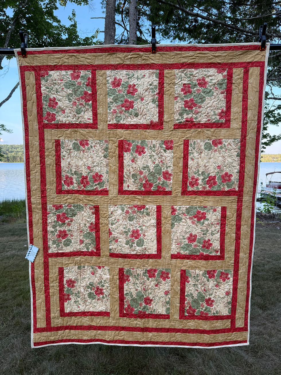 Handmade lap quilt with twelve large red floral print blocks on cream, framed in dark red & gold sashing, Bold Blocks pattern