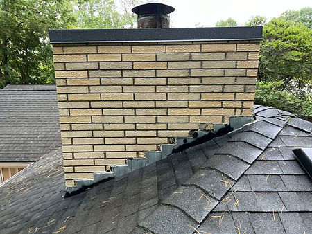 A chimney that has been cleaned with power washing, restoring its appearance to like-new condition. The surface is clear of soot and grime, revealing the original texture and color of the bricks.