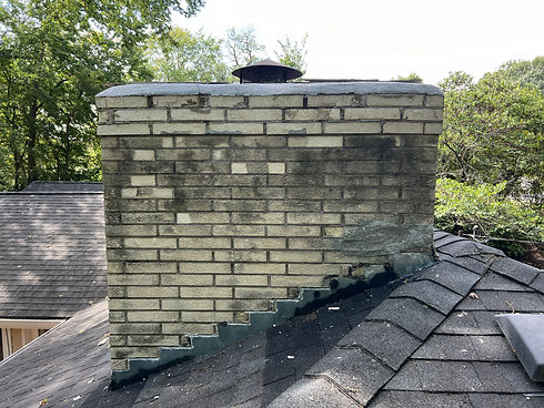 A chimney that has been cleaned with power washing, restoring its appearance to like-new condition. The surface is clear of soot and grime, revealing the original texture and color of the bricks.
