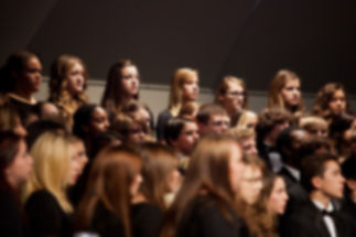 Abstract blur of students singing on stage inside auditorium..jpg