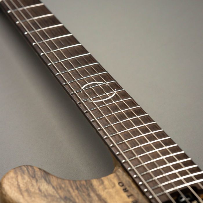 Detail shot of a wooden guitar neck, strings, and frets My Site