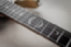 Guitar fretboard with crescent moon inlays