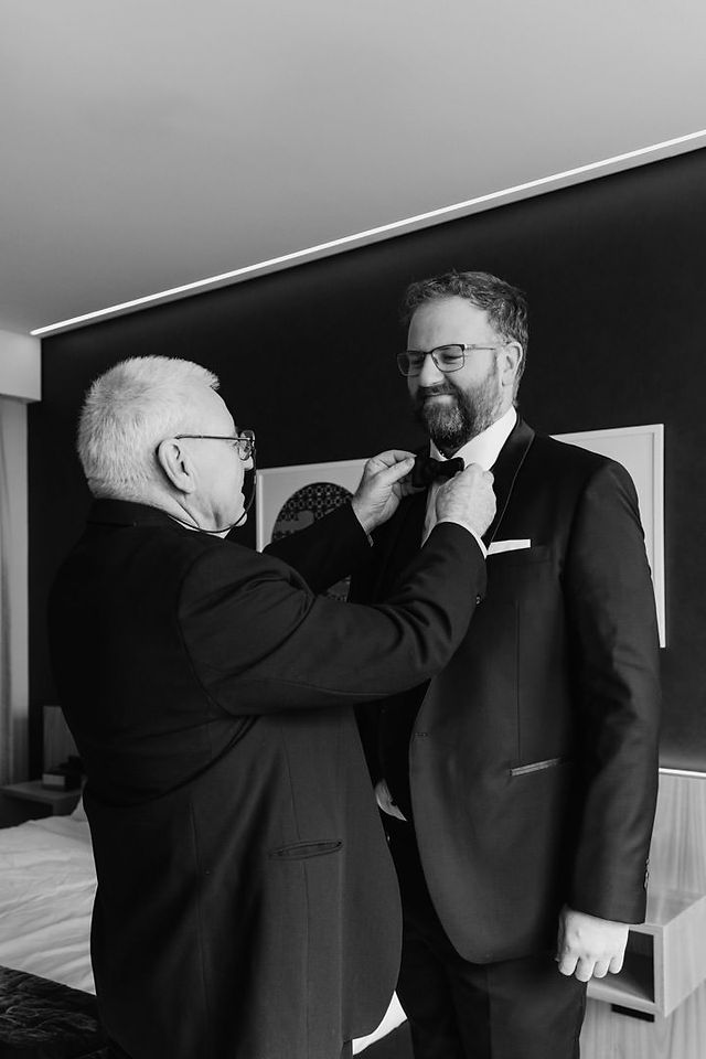Groom and father getting dressed