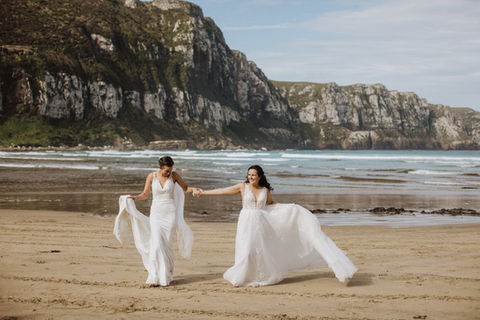 Two brides on the beach at Purakaunui Bay in the Catlins