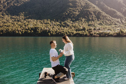 Man proposing to woman on the jetty at Bobs cove in Queenstown