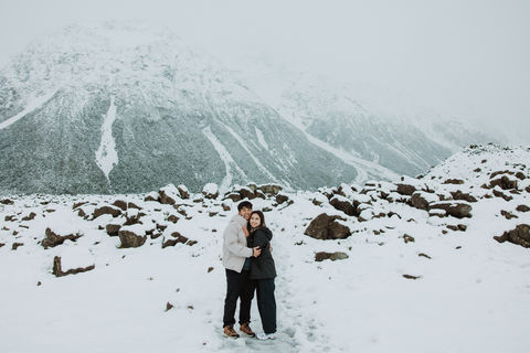 Couple standing together in the snow