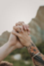 Couple holding hands together close up