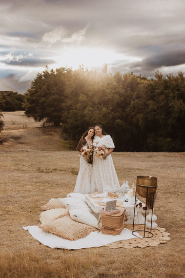 Two brides enjoy a sunset picnic in Wanaka, New Zealand