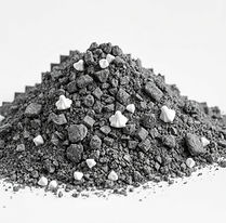 Pile of dark gray soil and small white rocks, close-up shot. called molar clay