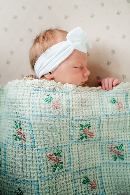 A newborn sleeps in her crib during a lifestyle newborn session in Morgantown, WV