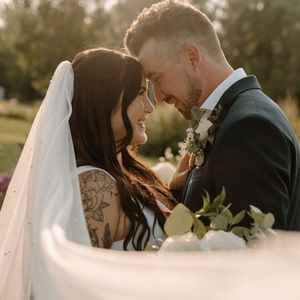bride and groom forehead to forehead, smiling