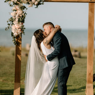 bride and groom kissing as they celebrate being husband and wife