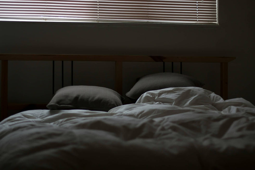 Dark and quiet bedroom promoting relaxation, stress relief, and better sleep through mindfulness and meditation practices to reduce anxiety and stress.