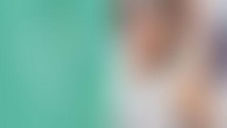 Woman in white raising her hand in a classroom setting