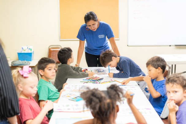 Students practicing Spanish with a teacher in a RHSA classroom