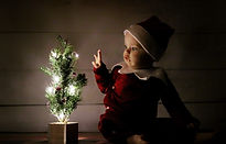 baby with a christmas tree baby's first christmas