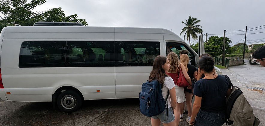 Students boarding group transportation during an En Route CaribEducation program