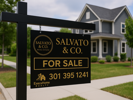 Black and gold “For Sale” sign by Salvato & Co. Real Estate with phone number 301 395 1241 and ExecuHome Realty logo, displayed in front of a simple two-story suburban home with gray siding and white trim.