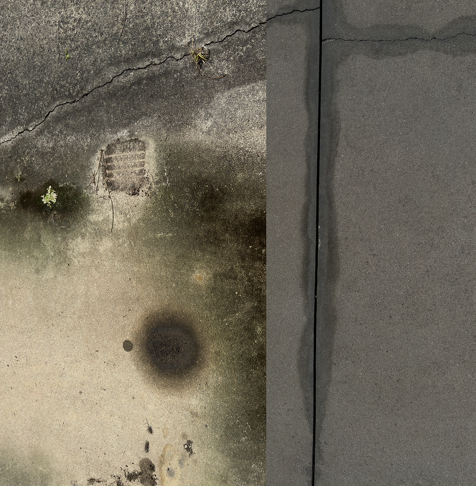 Damaged, stained pavement next to clean concrete