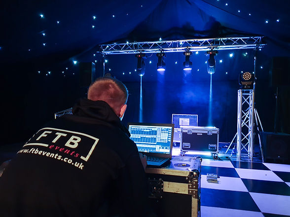 Event lighting technician programming light cues