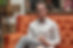 The mental health counselor that has created the site. He is sitting in a sofa, holding hands and looking to the lens.