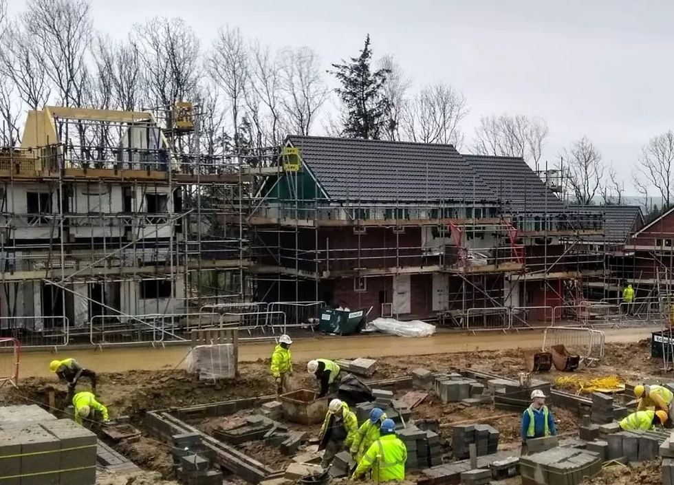 UK building site under CDM regulations with workers working in high visibility