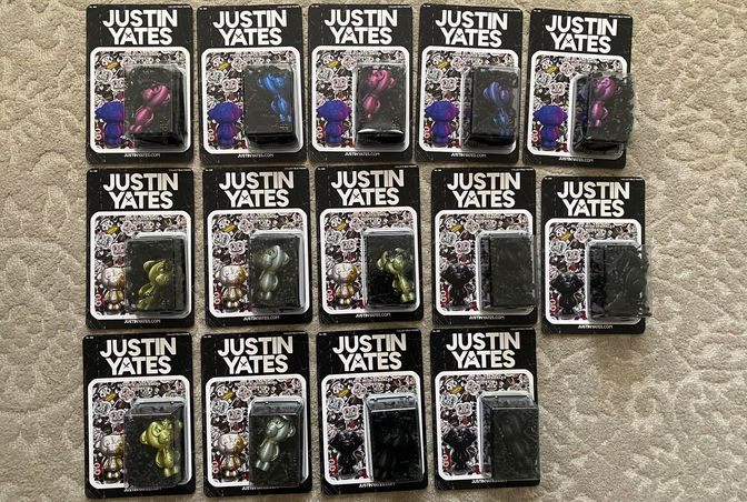 Several packages with various colorful monkeys aligned on the ground for display