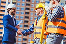 stock-photo-construction-worker-and-businessman-shaking-hands.jpeg
