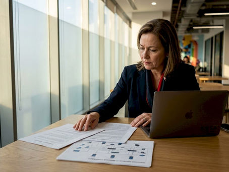 Executive reviewing managed IT documents in office