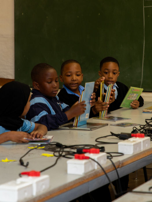 Volunteer assisting students at an after-school homework centre.