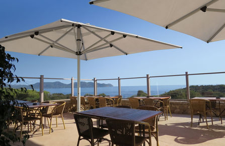Shadowspec SU10 Center Pole Umbrellas at an outdoor cafe