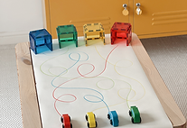 Colour-matching car play activity using magnetic tile garages, winding lines and toy cars to support early colour recognition