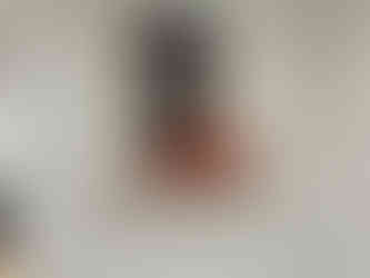 a framed painting of a man 's face is hanging on a white drywall