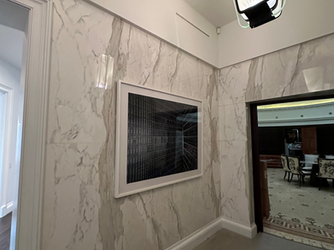 picture hanging on the tile wall in Manhattan apartment