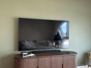85-inch TV wall mounting with soundbar installation in NYC apartment
