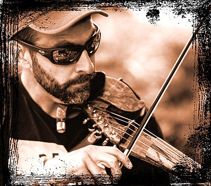 a sepia tone photo of Christian Brugger, original member and Violin player/Mandolin player of The LocoMojo Band.