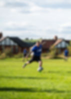 Second Team Player Taking a Kick