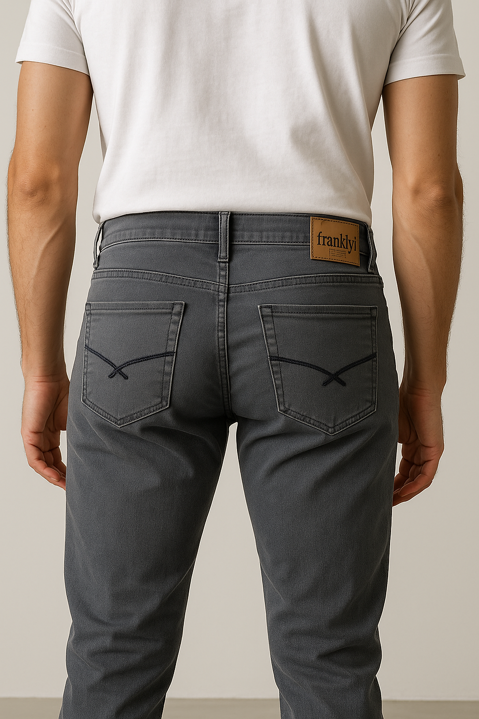 Thumbnail: Back view of Frankwil slim fit grey jeans with leather brand patch and deep pockets – paired with white t-shirt