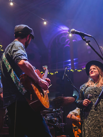 The String Beans band onstage under hanging lights at Just So Festival.