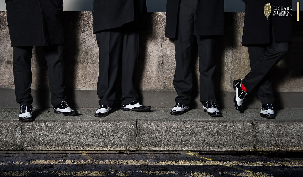 Afternoon Delight Barbershop Quartet wait for a bus in full regalia. You never know what your getting with this unique comedy vocal harmony group