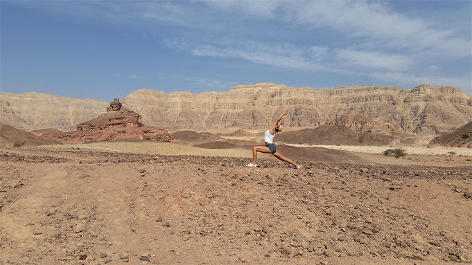 Woman practicing yoga in the desert