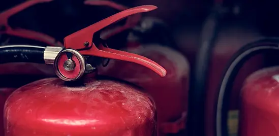closeup-of-red-fire-extinguishers-.webp