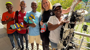 Volleyball coaching session with teachers and community coaches learning and practising skills in a vibrant schoolyard setting in Stellenbosch, South Africa.