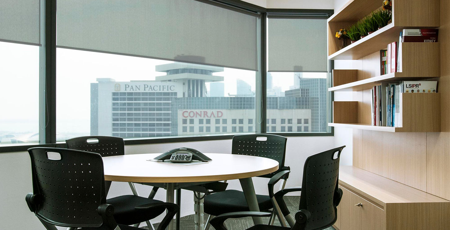 modern conference room featuring a large table surrounded by several chairs